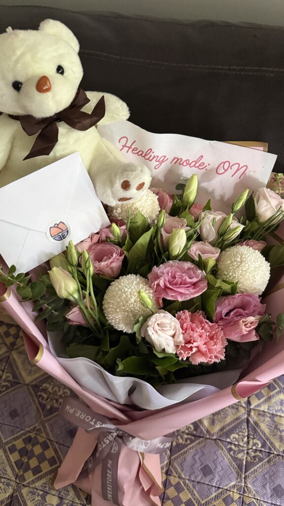 Bouquet of pink and white flowers with a white teddy bear and a note, with a message that says: HEALING MODE: ON